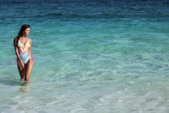 Woman in tropical sea. Beautiful woman in swimwear in tropical sea