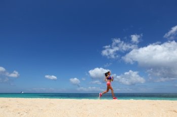 Woman jogging on beach . Running woman jogging on beach and sea on background
