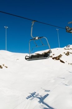Ski lift chairs on bright winter day
