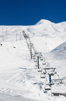 Ski lift chairs on bright winter day 
