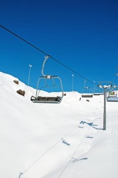 Ski lift chairs on bright winter day 