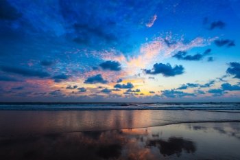 Tropical vacation holidays concept - sunset on idyllic beach. Baga, Goa, India