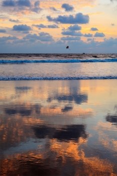 Tropical vacation holidays concept - sunset on idyllic beach. Baga, Goa, India