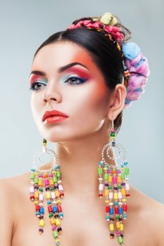 brunette girl in colourful earrings