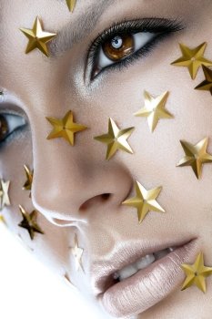 Close up portrait of a pretty woman with stars on face on a white background
