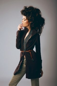 Vogue Style. Classy Fashion Model in Stylish Brown Jacket and Pants