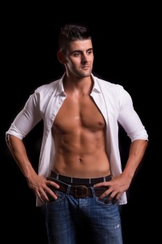 Handsome bodybuilder with a great body posing over a copy space background