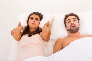 Portrait of an annoyed woman awaken by her fiance’s snoring