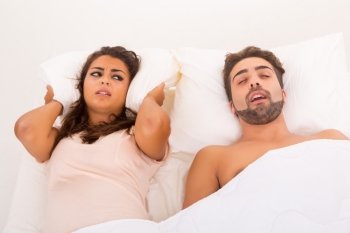 Portrait of an annoyed woman awaken by her fiance’s snoring