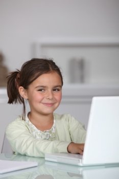 Little girl sat with laptop
