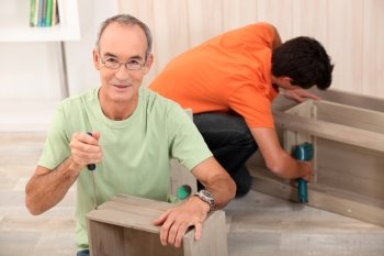 Father and son building furniture