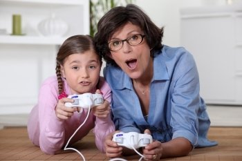 Mother playing vide-games with daughter