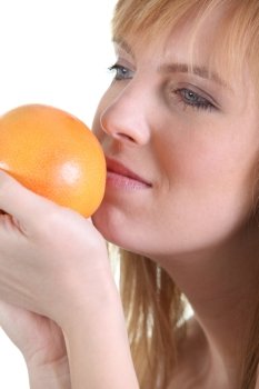 Woman smelling orange