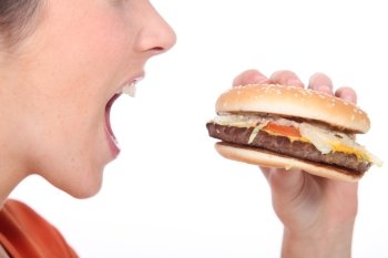 Woman eating cheeseburger