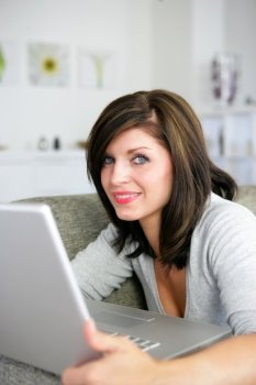 Brunette o the couch with laptop