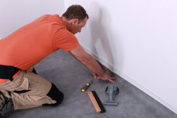 man installing linoleum
