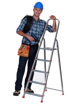Tradesman standing next to a stepladder