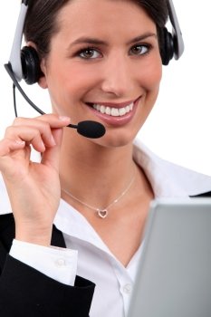 Woman with a headset and laptop