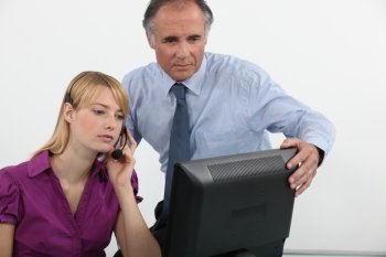 Businessman and woman at a computer