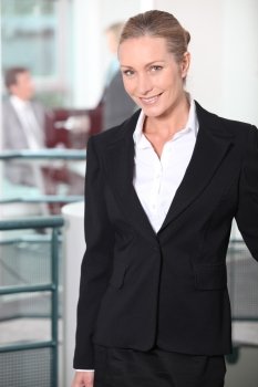 Smiling businesswoman standing in an office