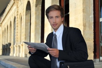 Young businessman looking at a paper