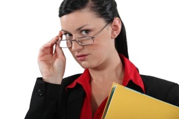 Clerical worker peering over her glasses