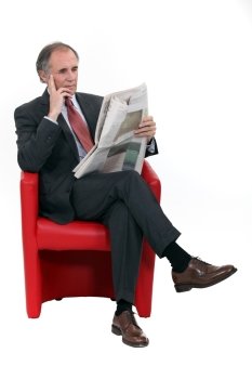 Mature businessman with a newspaper