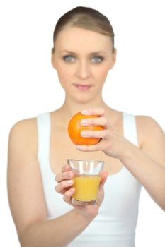 Woman squeezing fresh orange juice