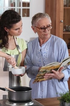 Mother and daughter cooking together