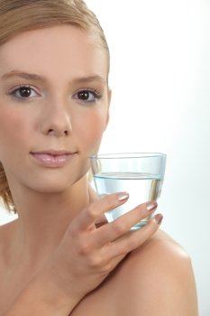 young girl holding glass of water