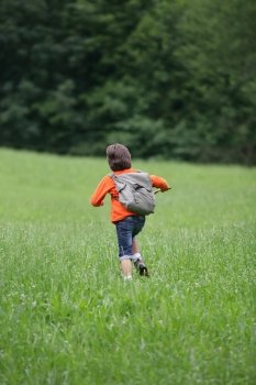 Boy running through the grass