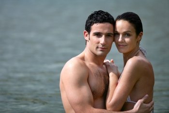 Couple embracing while bathing in the sea