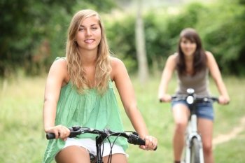 Two teenage girls cycling
