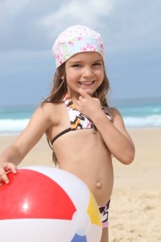 Young girl in a bandana with a beach ball