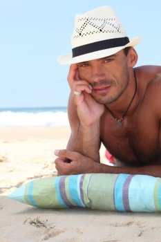Man on the beach in a straw panama hat