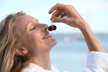 Woman smelling cherries
