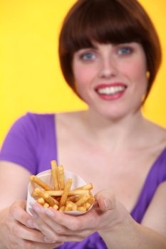 Young woman proposing French fries