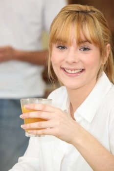Young woman drinking orange juice