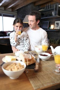 Man and little girl having breakfast