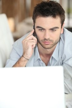 Serious man looking at laptop