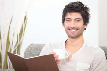 Man reading with coffee in hand