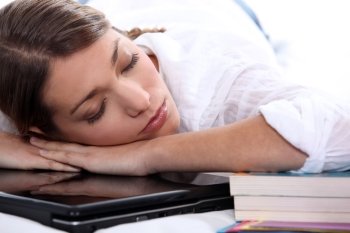 young woman sleeping on her computer