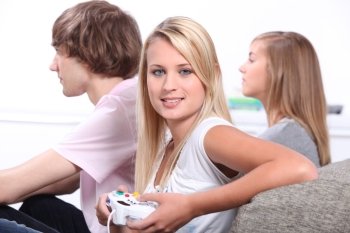 Three teenagers playing video games.