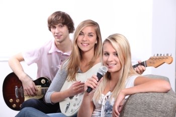 Three teenager playing musical instruments