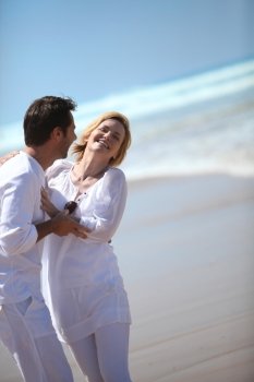 Couple laughing by the sea