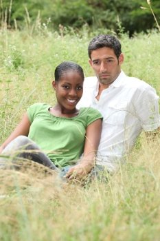 Couple sat in a field