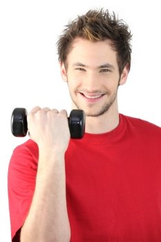 Portrait of smiling man lifting dumbbell