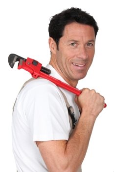 Labourer holding tool over shoulder