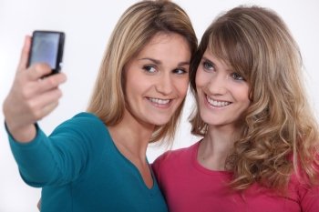 Two girls taking a picture of themselves.