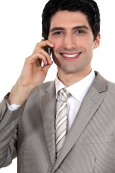 Happy businessman with mobile telephone